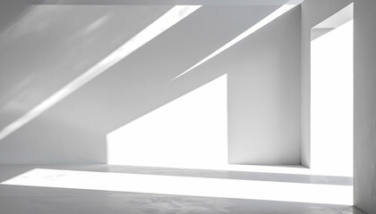 Obraz premium Interior space with bright natural light casting geometric shadows on white walls.