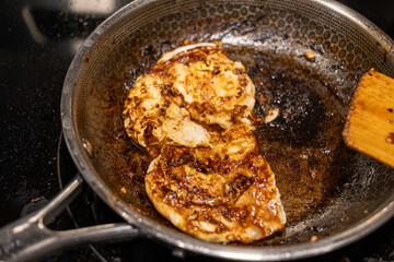 Delicious Chicken Breasts Cooking in a Skillet on a Stovetop
