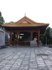 Traditional Chinese Pavilion with Stone Lion Statues in a Serene Courtyard Setting