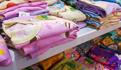 View of baby clothes in the store rack. 