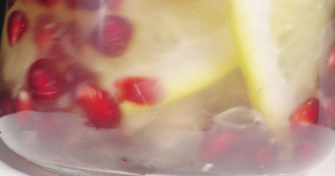 Mixing a fresh healthy berries juice in glass jar with macro shot of various fruits, probe dolly shot
