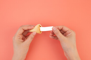 Hands Opening a Fortune Cookie with a Blank Message