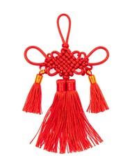 Close-up of a red Chinese knot with tassels against a white backdrop