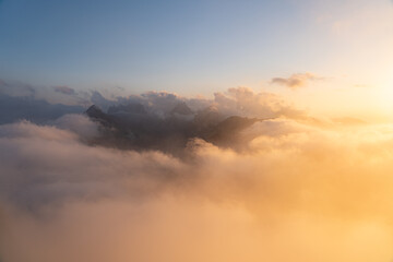 Golden sunset above the Hohen Kasten mountain in Appenzell, Switzerland. Stunning view over the Alps and the Rhine Valley with glowing clouds and peaceful alpine atmosphere.
