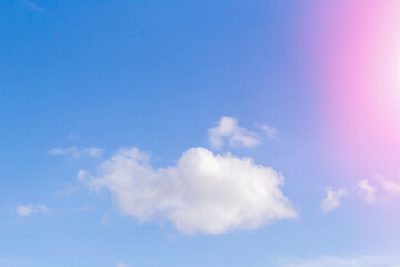 White airy beautiful clouds in a bright blue sky. Clear sunny weather. The concept of environmental safety and cleanliness..