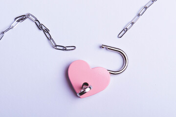 Breaking up a love relationship. Family divorce. Family happiness. The red heart is tied with a chain and a padlock. Love concept.