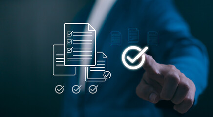 Digital Quality Assurance concept. Hand verifying a checklist icon, symbolizing business compliance, standards management, and successful audit completion.