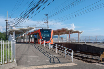 Orange Iyotetsu Train at the seaside station, Baishinji Station, Matsuyama, Ehime, Shikoku, Japan