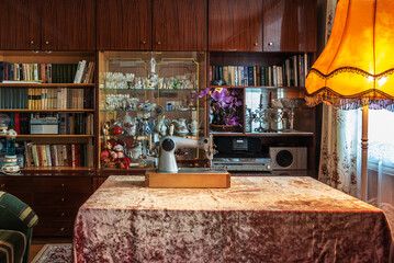 The typical furnishings of a living room in an apartment of a city apartment building from the time of the former Soviet Union of 1960-1980.
