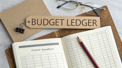 Budget Ledger Open on Wooden Table with Glasses and Clip, Organizer for Personal Finance, Planning, and Financial Management