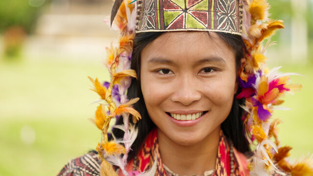headshot portrait of a woman wearing a barkcloth or bark cloth traditional dress in rampi, sulawesi, indonesia