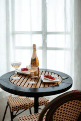 Table with food and drink near a window