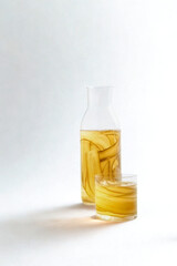 Yellow capsules in a clear bottle with cap nearby