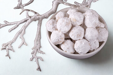 Winter holiday decoration with frosted branches and ornaments