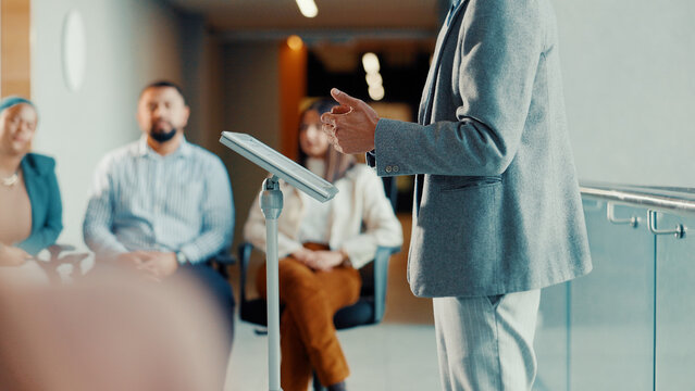 Fototapeta Podium, speaker and hands with audience at conference, workshop or symposium for skill development. Corporate talk, presenter person with discussion or keynote speech at upskill seminar in business
