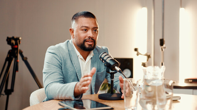 Conversation, microphone and podcast with man in studio for broadcast, interview or live streaming. Radio, subscription entertainment and talk show with host in production office for recording