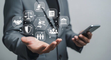 Businessman holding smartphone with holographic legal and justice icons floating above open palm representing digital law and online legal services