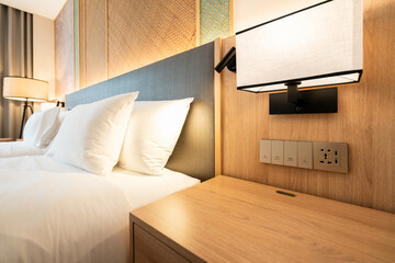 Modern Hotel Bedroom Close-Up: Bed, Nightstand, and Universal Power Outlets