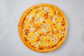 A four-cheese pizza sits atop a wooden board. The crust is golden