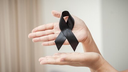 Honoring life funeral with black ribbon emotional tribute personal reflection indoor setting