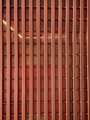 Close up of fluted metal strips with wiremesh and perforated metal finished in copper metallic paint. Suitable for screens, partition, and door. Modern industrial concept. Seamless background texture. © TMR Studio