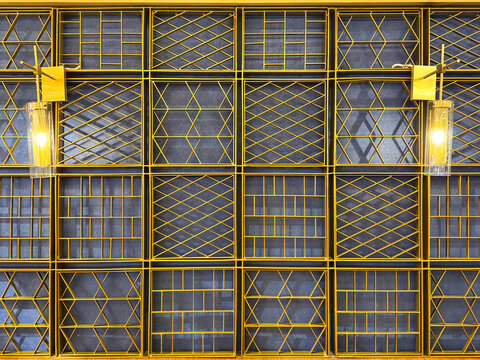 Series of decorative and ornamental wall screens panel in modern abstract geometrical, diamond, and rectangular shapes. Finished in gold metallic color, with blue background. Seamless - Powered by Adobe