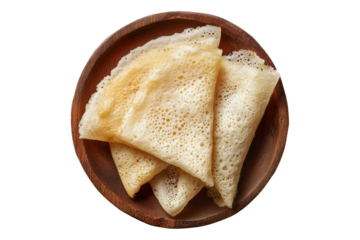 Rolled Brazil tapioca sweet crepe with airy texture on wooden plate, isolated on white transparent background, concept of traditional South American Cuisine