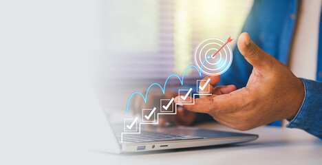 Businessman planning goals with digital checklist and target strategy, success achievement steps,...