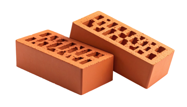 Two orange clay bricks with hollow grid pattern sit diagonally against a black background in a studio shot