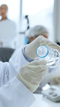 Scientist, hands or pouring liquid in lab for biology experiment, medical research or pathology. Science person, water and formaldehyde solution for cell maintenance, chemistry or cleaning equipment.