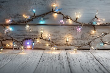 Colorful string lights with glowing bulbs are elegantly draped over rustic wooden planks, creating a warm and inviting atmosphere for festive celebrations and cozy gatherings
