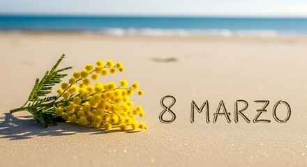 Mimosa flowers on sandy beach with 8 Marzo text for International Womens Day.