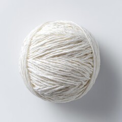A ball of white yarn, centered against a bright white background