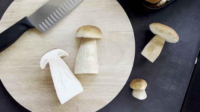 Top view of fresh boletus mushroom on wooden cutting board 