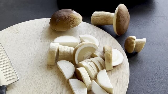 Close up of fresh cutted boletus mushroom on wooden cutting board 
