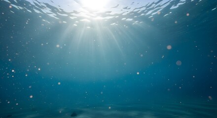 Ethereal sunbeams illuminate the clear blue ocean depths, creating a tranquil underwater light display with suspended particles shimmering in pristine marine waters
