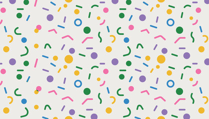 Scattered colorful confetti sprinkles and shapes on a light background pattern