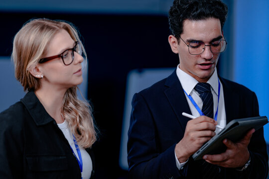 Unveiling the future. Smiling innovator presents a groundbreaking algorithm or quantum code on screen, explaining the next leap in AI or complex computation to his excited team.