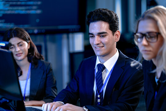 Code compiled success. Smiling developer celebrates breakthrough with team late night coding session solving complex bug collaborative tech win achievement unlocked.