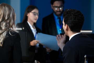 Data integrity check night shift Diverse team meticulously audits financial performance comparing figures tablet screen printed reports ensuring accuracy crucial validation process underway hub.