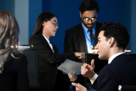 Data integrity check night shift Diverse team meticulously audits financial performance comparing figures tablet screen printed reports ensuring accuracy crucial validation process underway hub.