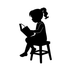 Silhouette of a young girl sitting on a stool reading a book