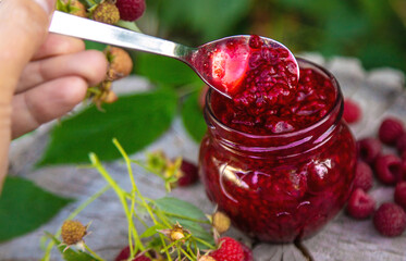 Raspberry jam in the garden. Selective focus.