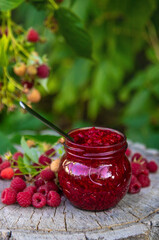 Raspberry jam in the garden. Selective focus.