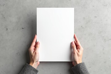 Blank A4 paper mockup held by businesswoman's hands for flyer, poster or resume presentation over a grey background