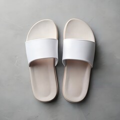 Pair of Simple White and Beige Slides on a Textured Gray Surface sandals footwear