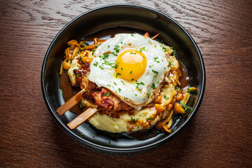 A brunch dish overflowing with flavor, served on a wooden table with vibrant colors and textures