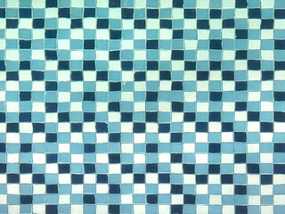 Fototapeta premium Close up of blue mosaic tiles suitable for swimming pool tiles.. Blue glazed and glossy tiles for pool flooring or wall. For landscape pool design. Seamless background texture.