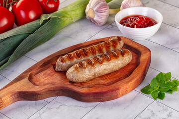 Grilled pork sausages served tomato sauce