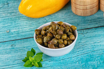 Pickled canned capers in the bowl